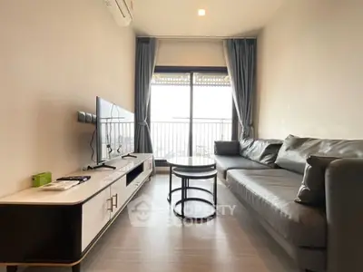 Modern living room with sleek furniture and balcony view