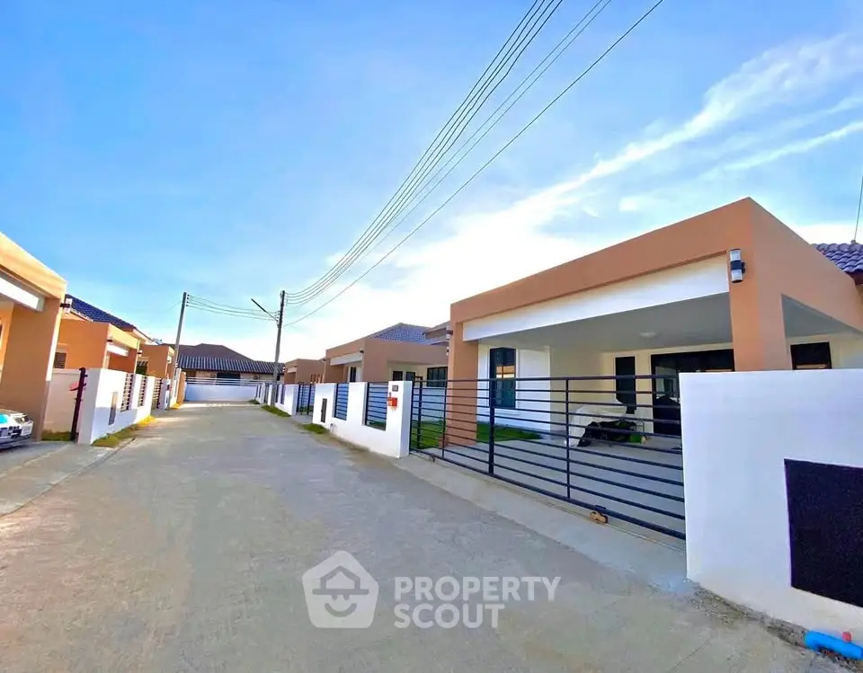 Modern single-story homes with gated entrances in a serene neighborhood setting.