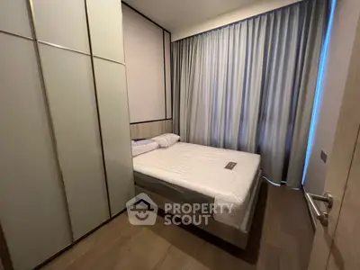 Modern bedroom with sleek design and floor-to-ceiling curtains