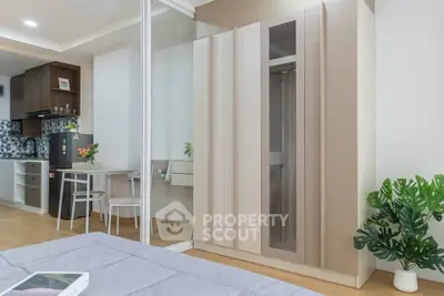 Modern bedroom with sleek wardrobe and open kitchen layout