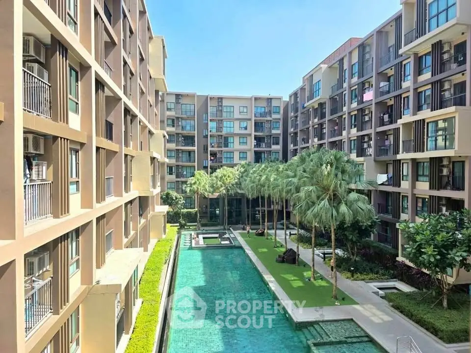 Modern apartment complex with pool and lush landscaping, offering a serene urban oasis.