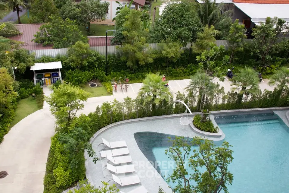 Luxurious outdoor pool area with lush greenery and modern design, perfect for relaxation and leisure.
