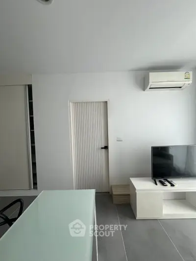 Modern living room with sleek TV stand and air conditioning unit