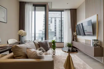 Modern living room with elegant decor and large windows offering city view.