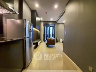 Modern apartment interior with sleek kitchen and cozy living area, featuring stylish furniture and contemporary design.