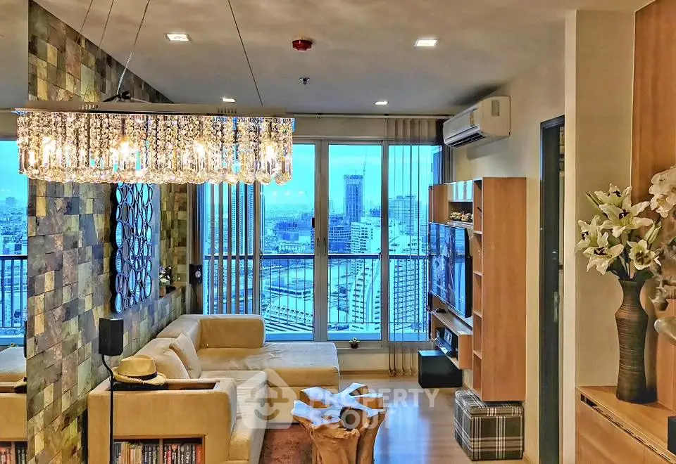 Luxurious living room with city view, elegant chandelier, and modern decor in high-rise apartment.