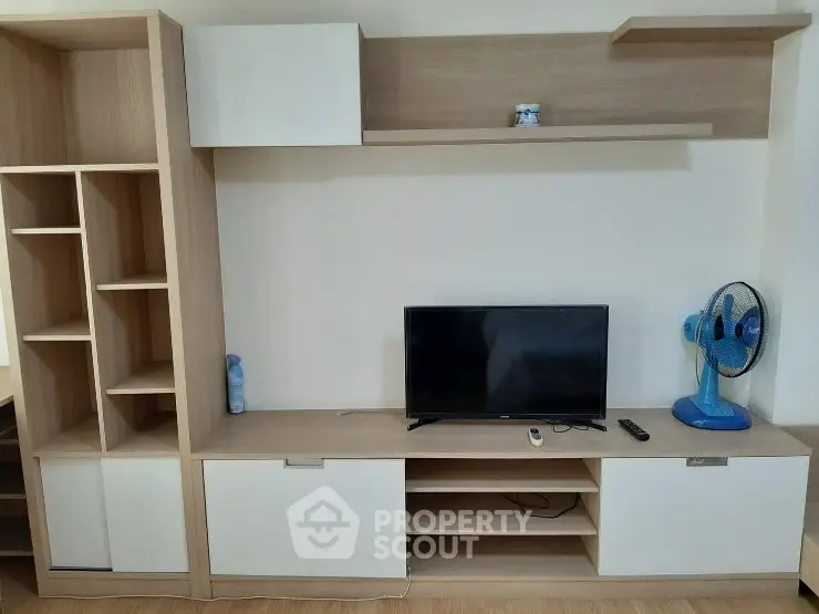 Modern living room with sleek TV stand and shelving unit, perfect for stylish storage solutions.