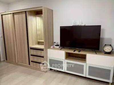 Modern living room with sleek wooden furniture and flat-screen TV