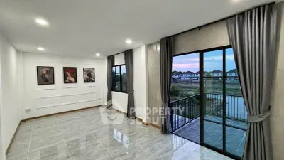 Spacious living room with large windows and balcony overlooking serene neighborhood view.