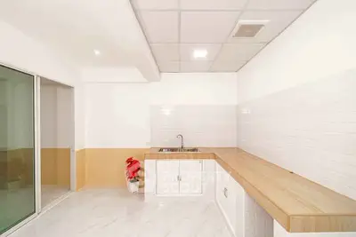 Modern kitchen with sleek countertops and white cabinetry in a bright, minimalist design.