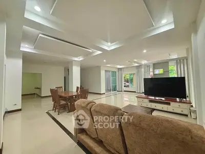 Spacious open-plan living room with modern furnishings and ample natural light