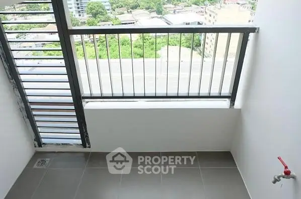 Spacious balcony with city view and tiled flooring in modern apartment