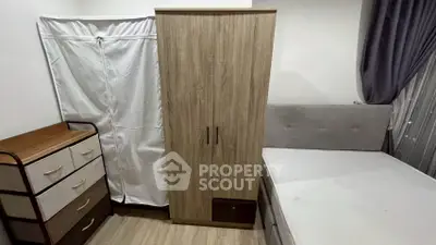 Cozy bedroom with modern wardrobe and comfortable bed