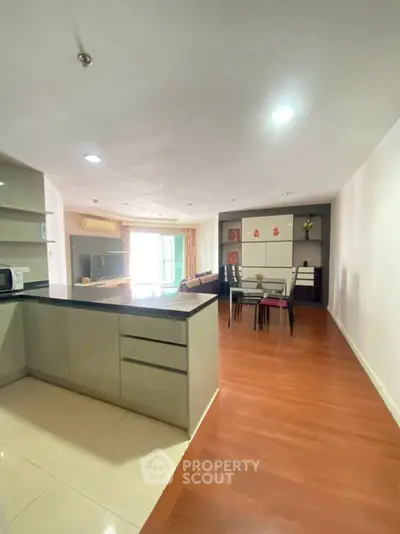 Spacious open-plan kitchen and dining area with modern design and ample natural light.