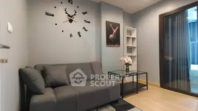 Modern living room with stylish decor and comfortable gray sofa, featuring a unique wall clock and elegant artwork.