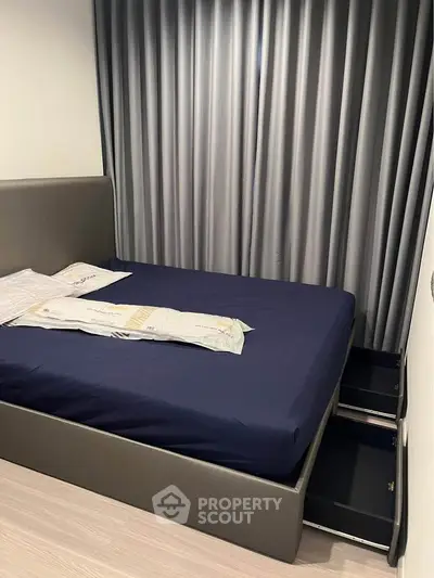 Modern bedroom with sleek design and storage bed in stylish apartment.