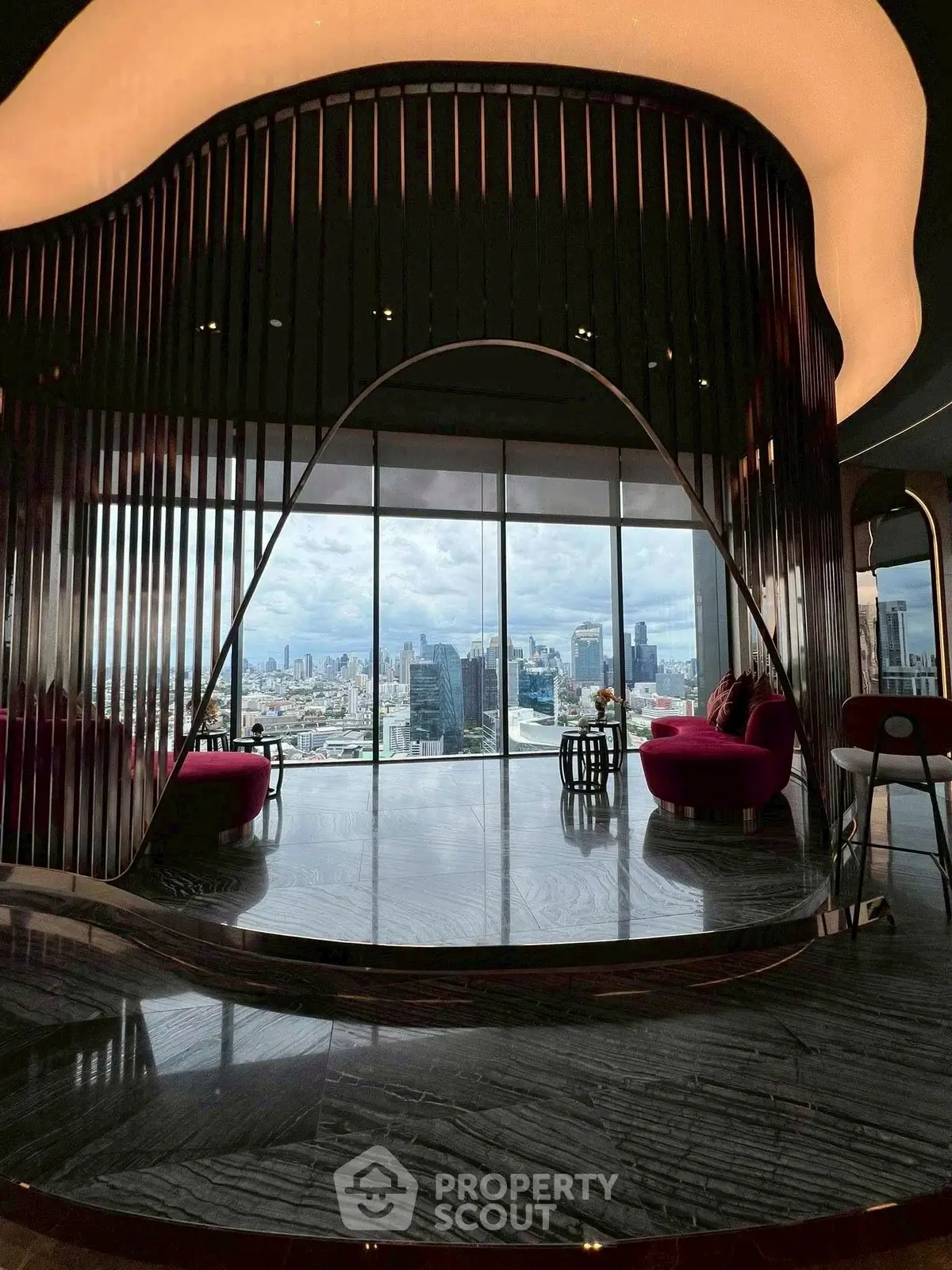 Luxurious modern living room with stunning city skyline view and elegant design.