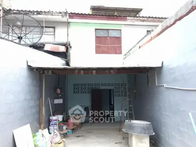 Charming fixer-upper with spacious courtyard and potential for renovation.