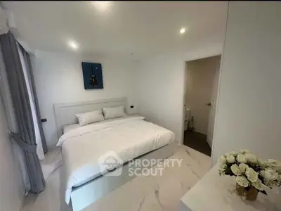 Modern minimalist bedroom with white decor and elegant lighting
