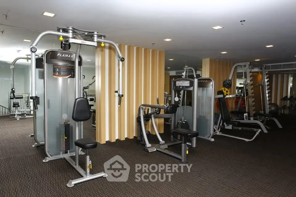 Spacious modern gym with state-of-the-art fitness equipment in a luxury residential building.