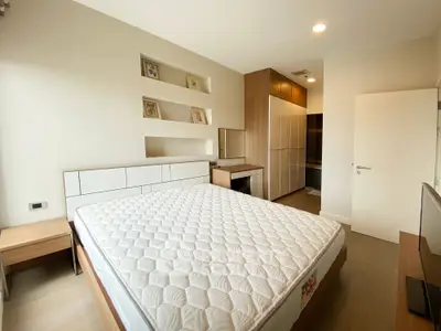 Spacious bedroom with modern design and ample storage in a luxury apartment.