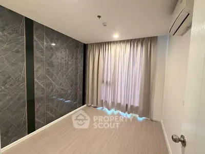 Modern empty room with marble accent wall and large window, perfect for customization.