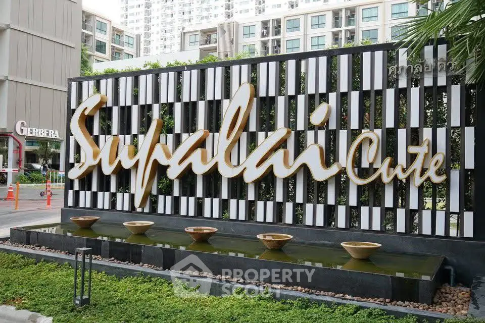 Modern Supalai Cute building entrance with stylish signage and water feature