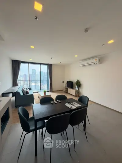 Spacious modern living room with city view and elegant dining area