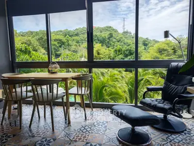 Charming living room with scenic view, stylish furniture, and patterned tile flooring.