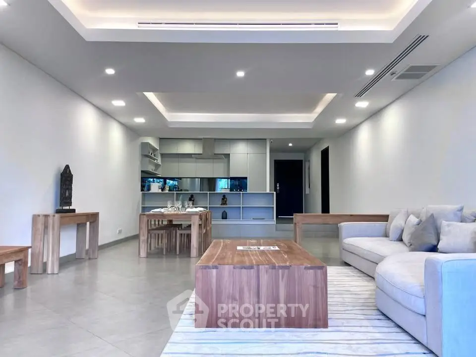 Spacious modern living room with open kitchen and elegant wooden furniture