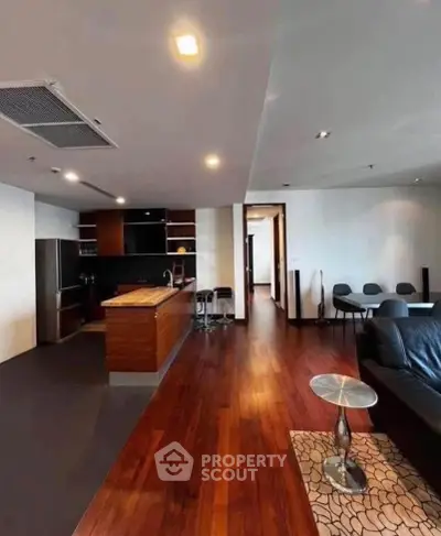 Spacious modern living room with open kitchen and elegant wooden flooring