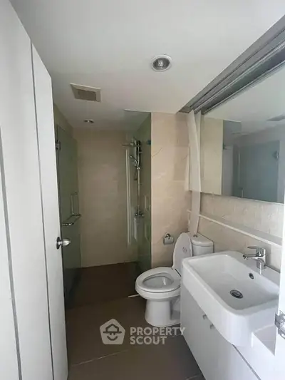 Modern bathroom with sleek fixtures and glass shower enclosure