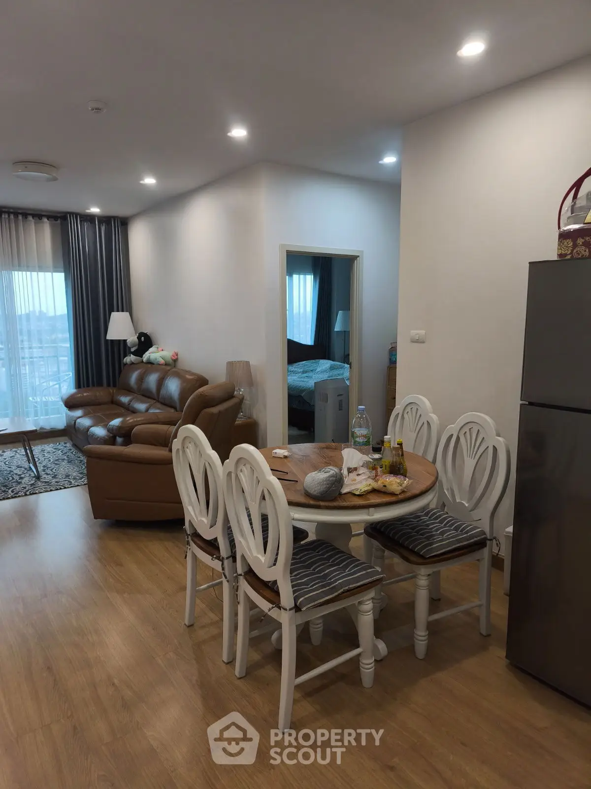 Cozy open-plan living and dining area with modern furnishings and natural light.