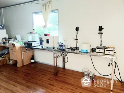 Spacious laboratory setup with modern equipment and wooden flooring