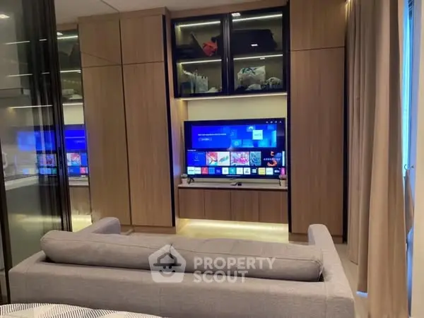 Modern living room with sleek entertainment center and cozy gray sofa