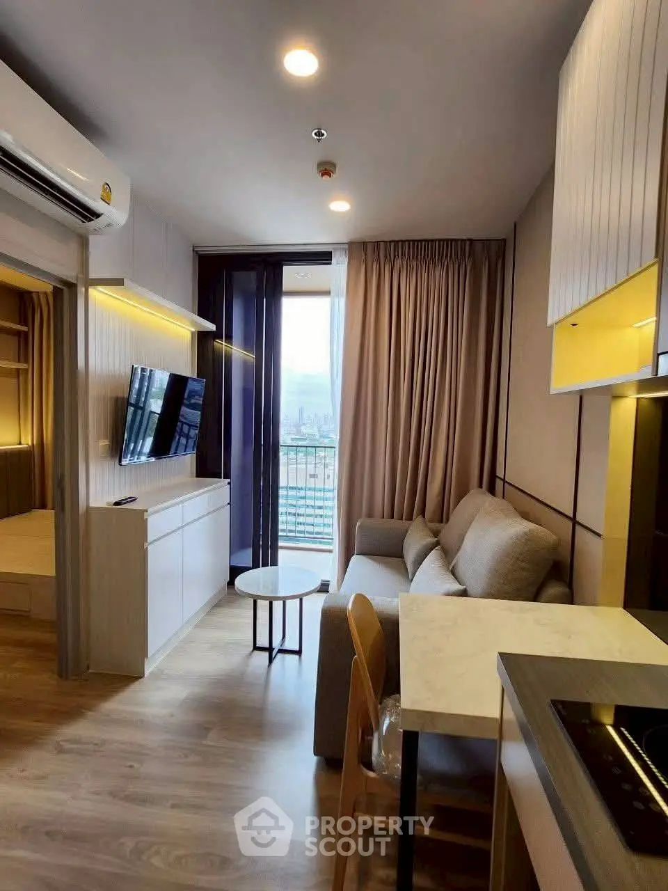 Modern living room with open kitchen and city view balcony in stylish apartment