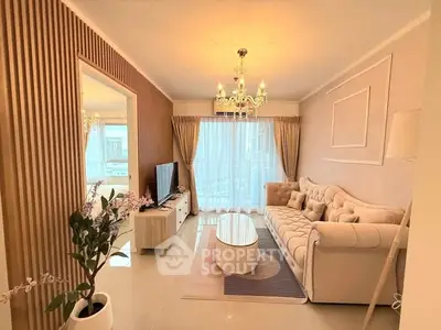 Elegant living room with chandelier, plush sofa, and modern decor