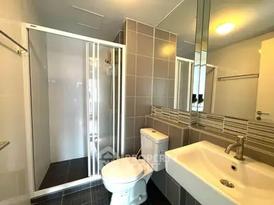 Modern bathroom with sleek shower and stylish fixtures in contemporary apartment.