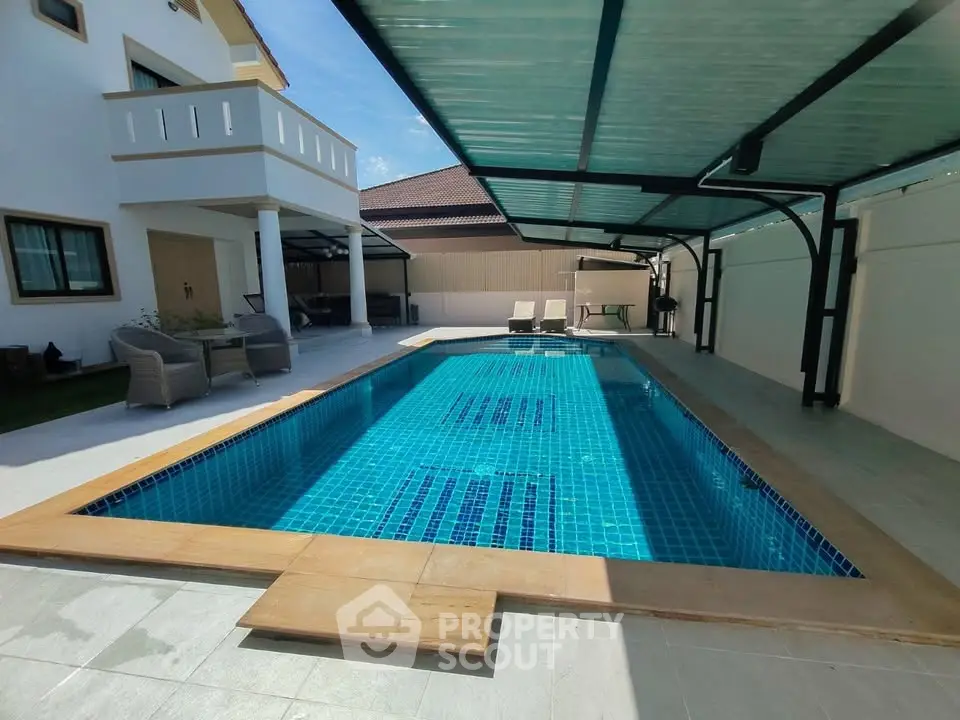Luxurious private pool area with modern design and covered seating, perfect for relaxation and entertainment.
