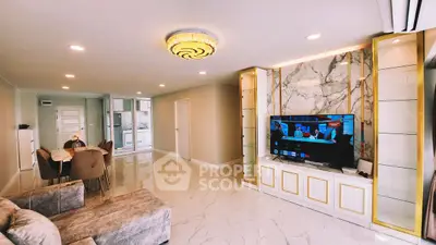 Luxurious living room with marble flooring and elegant decor, featuring a modern entertainment center.