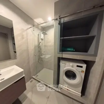 Modern bathroom with sleek shower and washing machine