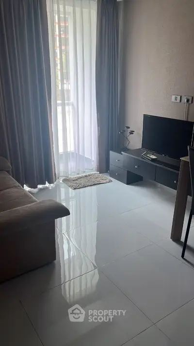 Modern living room with sleek TV setup and natural light