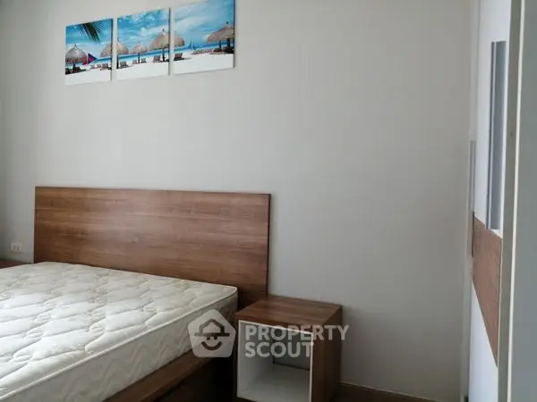 Modern bedroom with wooden furniture and beach-themed wall art