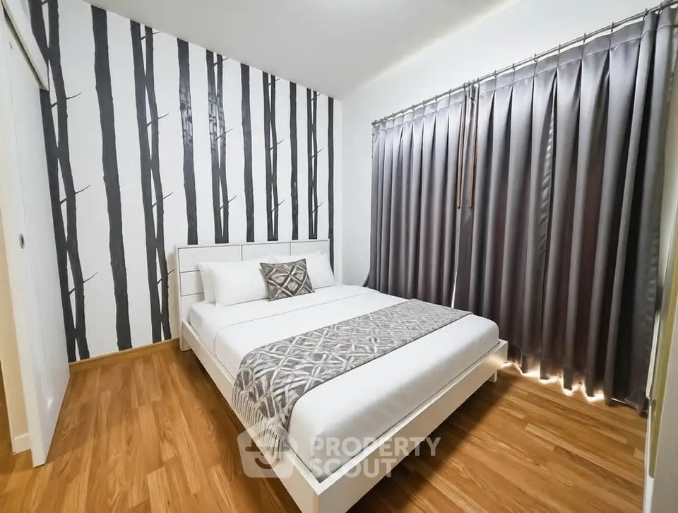 Modern bedroom with stylish decor and wooden flooring