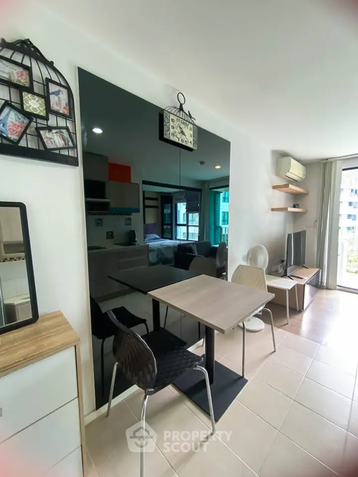 Modern living room with dining area and large mirror in stylish apartment