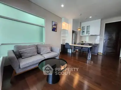 Modern open-plan living room with stylish furniture and kitchen area