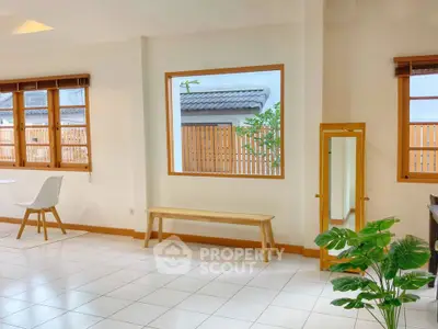 Bright and airy interior with large windows and modern decor