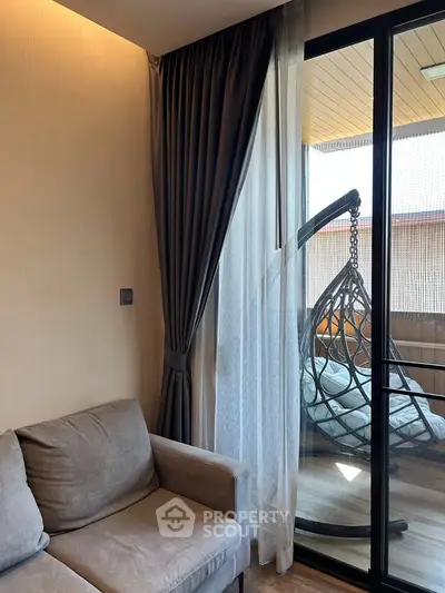Cozy living room with elegant curtains and a stylish balcony swing chair.