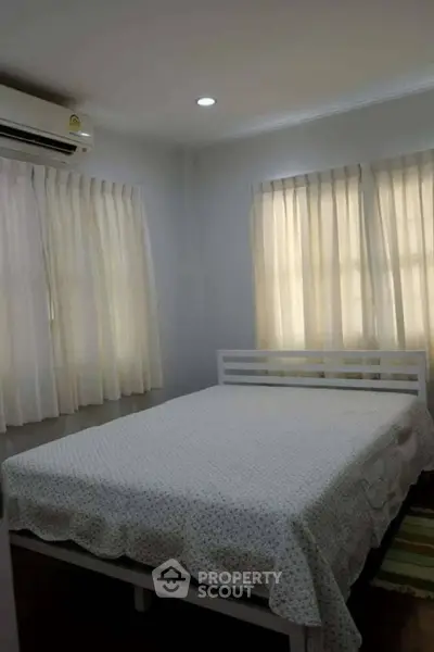 Cozy bedroom with natural light and air conditioning
