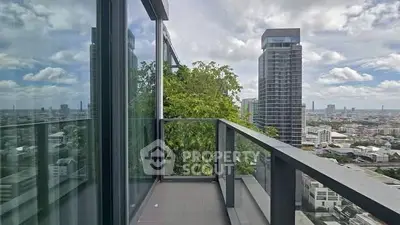 Stunning high-rise balcony with panoramic city views and modern glass railing.